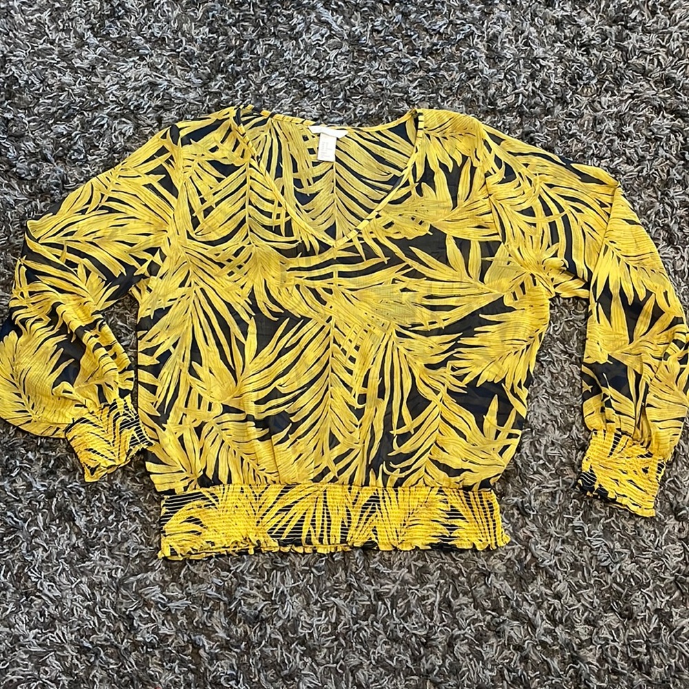 H&M sheer blouse with white leaves with dark blue background